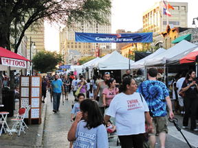 Booths lined the street at the Pecan STreet FEstival selling everything from food to jewelry. 
