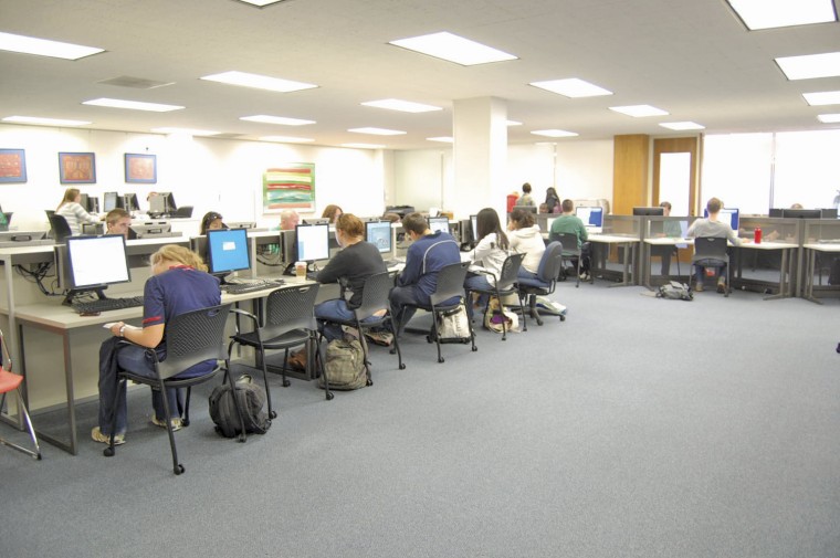 Students take advantage of newly designed work spaces in the library, which has added new computers.
