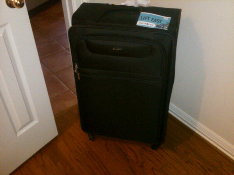 My empty suitcase stares longingly at me from the corner.