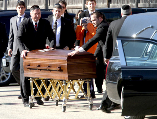 The casket of Aaron Swartz, the Reddit co-founder and Internet activist, is moved to a waiting hearse during his funeral.
