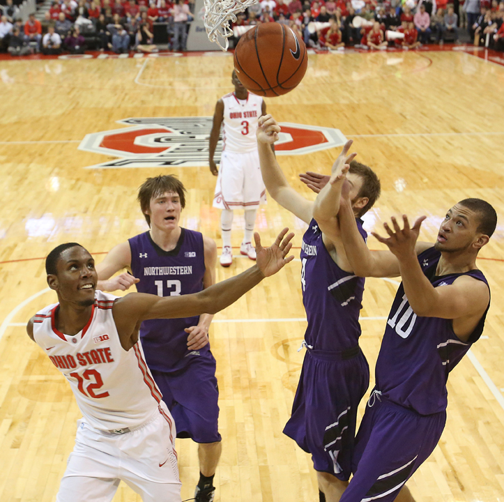 Ohio States Sam Thompson, left, fights for a rebound against Northwesterns Kale Abrahamson (13), Alex Marcotullio (4) and Mike Turner (10) in the first half at the Value City Arena in Columbus, Ohio, on Thursday, February 14, 2013. Ohio State pulled out a 69-59 triumph. 
