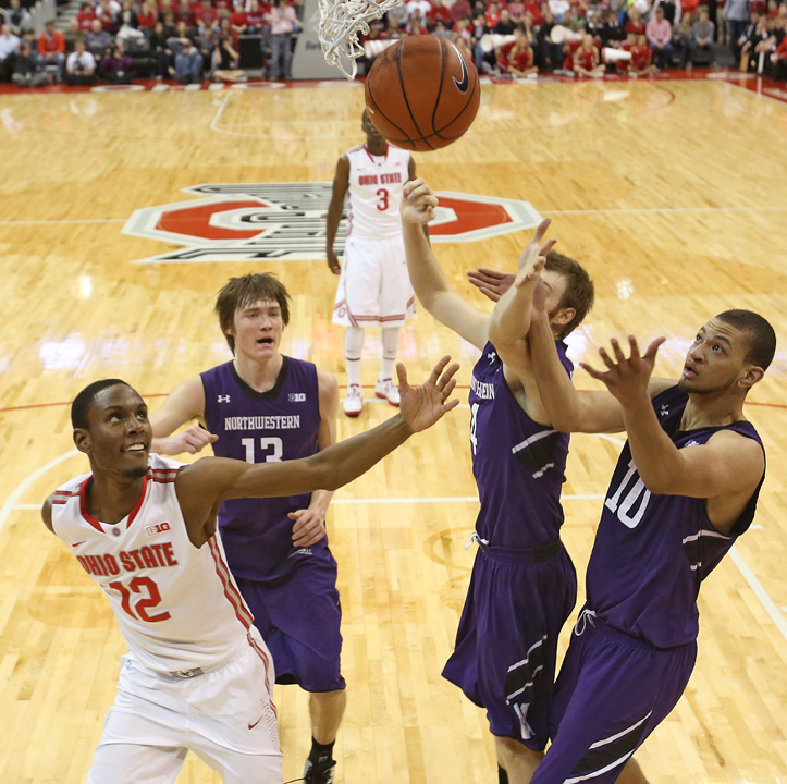 Ohio State's Sam Thompson, left, fights for a rebound against Northwestern's Kale Abrahamson (13), Alex Marcotullio (4) and Mike Turner (10) in the first half at the Value City Arena in Columbus, Ohio, on Thursday, February 14, 2013. Ohio State pulled out a 69-59 triumph. 
