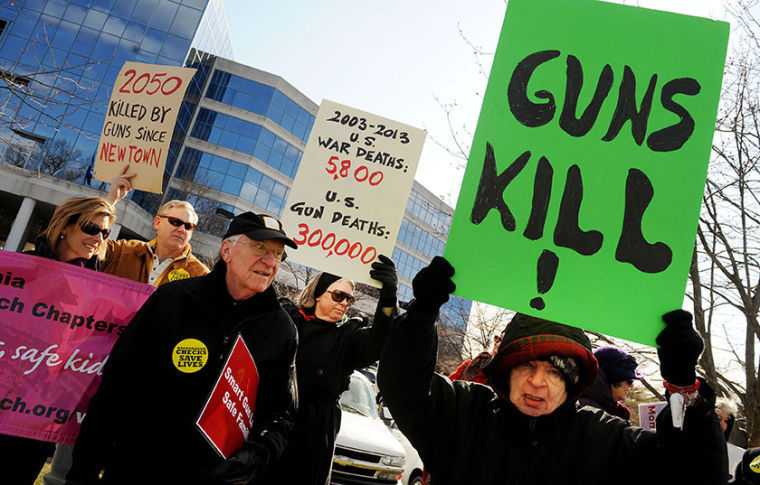 MomsRising holds a rally in front of the National Rifle Association (NRA) office, in support of common-sense gun regulations.
