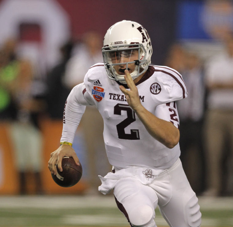 Texas A&amp;M quarterback Johnny Manziel runs for a 5-yard touchdown in the second quarter againstOklahoma in the AT&amp;T Cotton Bowl.