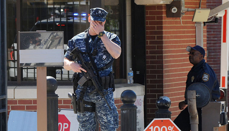 A soldier stands guard at the front gate of the Washington Naval Yard.