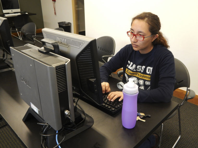 Janie Coronado sits in one of the computer labs experiencing printer problems on campus.