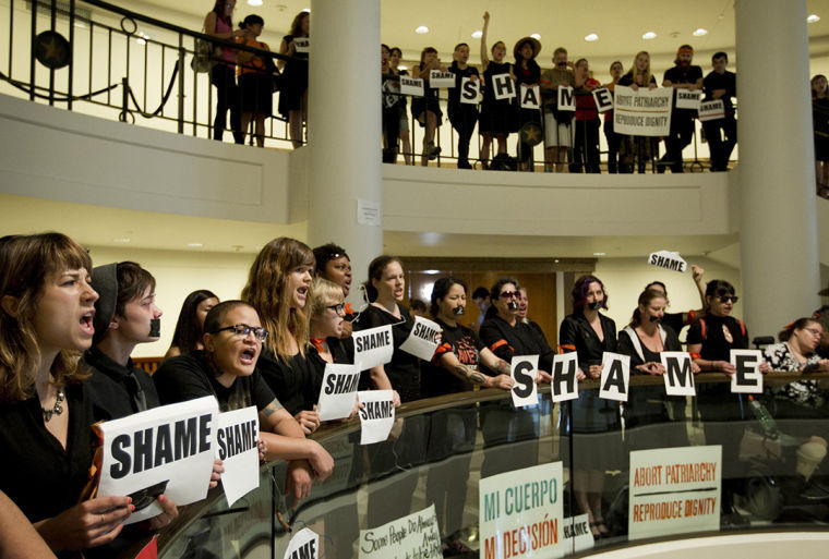 Abortion rights supporters demonstrate outside the Capitol in Austin, Texas, where Gov. Rick Perry signed the abortion restriction bill, House Bill 2, Thursday, July 18, 2013. 