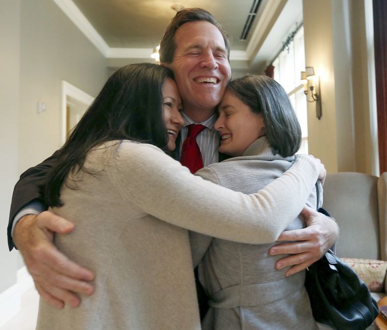 Cleopatra de Leon and Nicole Dimetman hug attorney Neel Lane after Judge Orlando L. Garcia ruled Texas's ban on same-sex marriage to be unconstitutional.