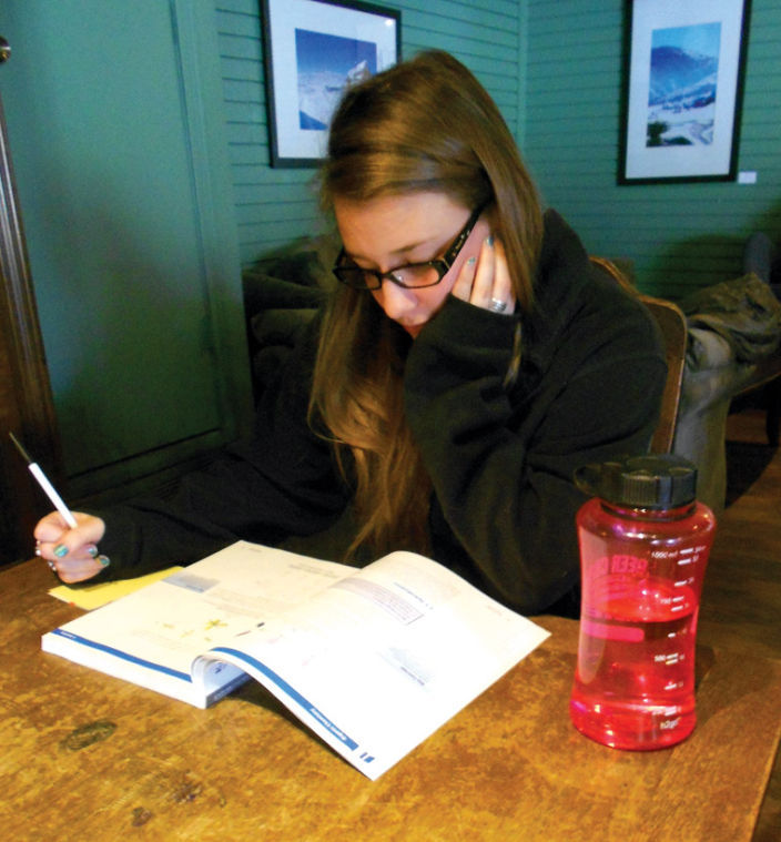 December graduate and aspiring medical student Nicole Wellman studies at a local coffee shop.