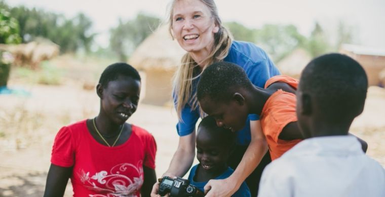 Smiles and little hands surround Jameson while in Uganda.