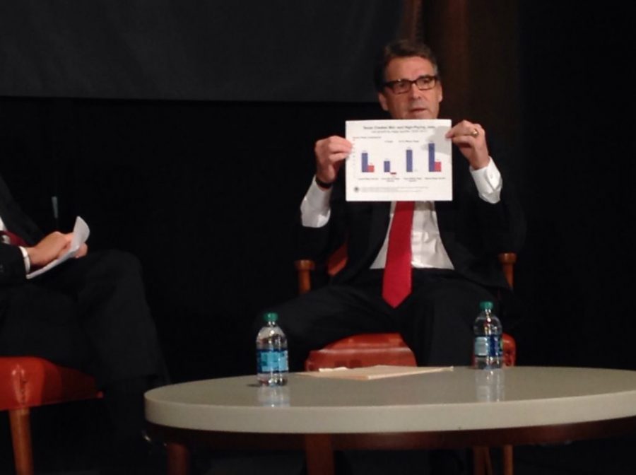 Texas Gov. Rick Perry holds up a chart explaining where jobs have been created by level of wages.