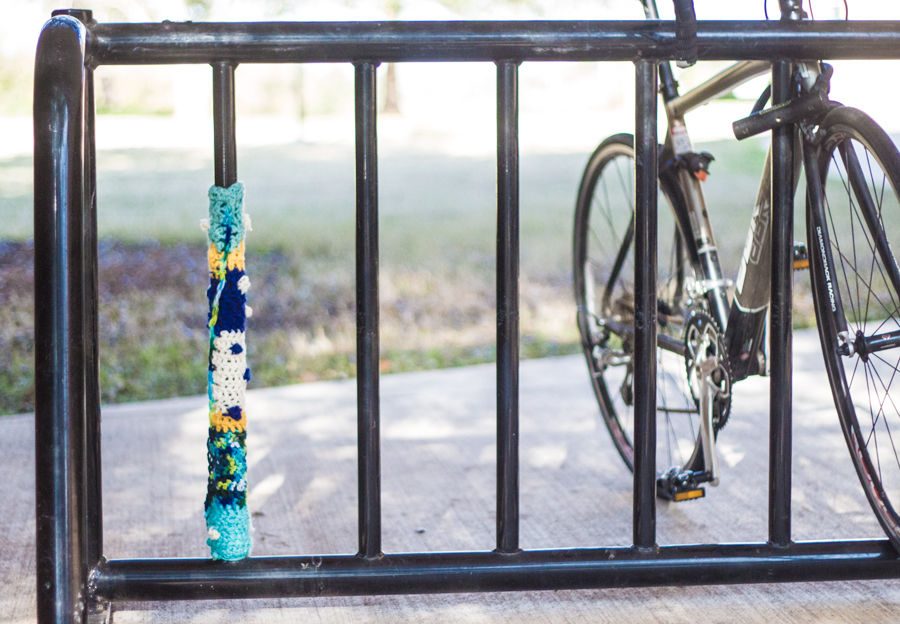 A crochet form of graffiti created around one of the universities bike racks. 