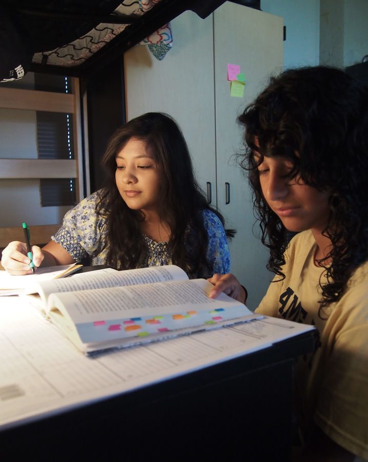 Sophomore Magaly Vargas, left, and freshman Isabel Martinez study inside a friend’s room in Johnson Hall. The Village was built in 2009; it is currently the newest residence hall.