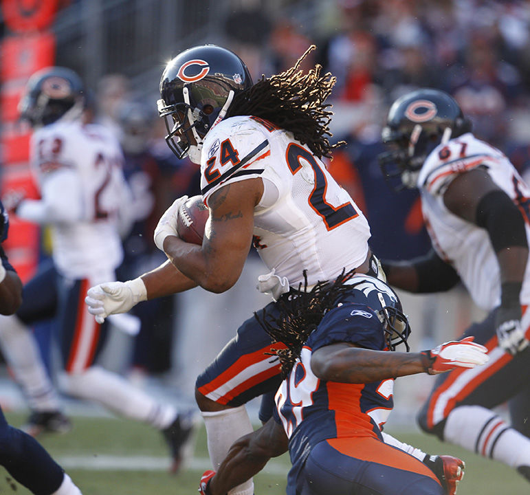 Chicago Bears running back Marion Barber (24) runs past Denver Broncos defensive back Jonathan Wilhite (29) during the first half of their game at Mile High Stadium in Denver, Colorado, on Sunday, December 11, 2011. (Nuccio DiNuzzo/Chicago Tribune/MCT)