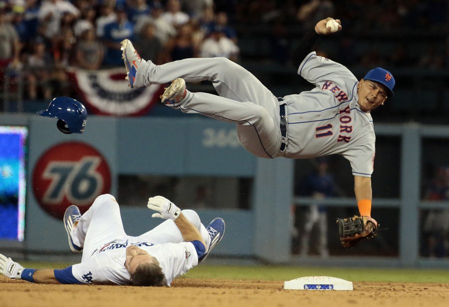 The Los Angeles Dodgers' Chase Utley upends New York Mets shortstop Ruben Tejada (11) to break up a potential double play in the seventh inning at Dodger Stadium in Los Angeles on Saturday, Oct. 10, 2015. (Robert Gauthier/Los Angeles Times/TNS)
