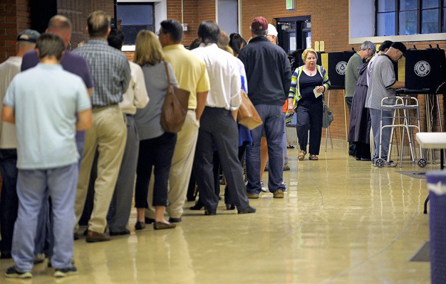 Voters line up at the polling site at Paschal High School in Fort Worth, Texas, on Tuesday, Nov. 4, 2014. 