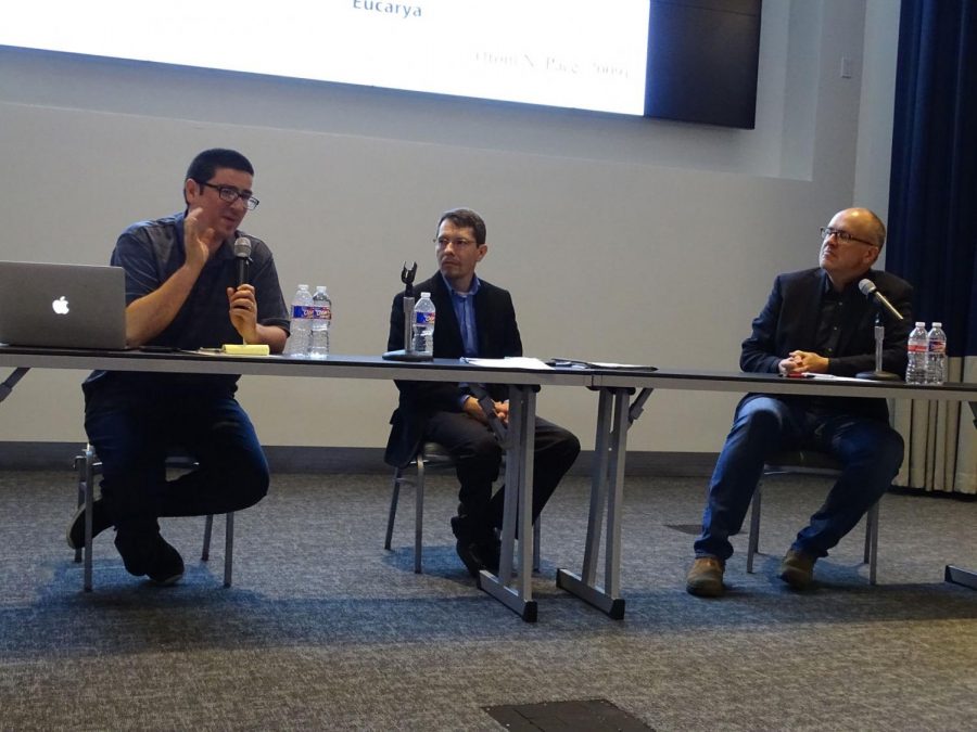 Joel Velasco, left, Stephen Dilley, center, and Paul Nelson, right, at a debate about Darwins evolution theory Oct. 21.