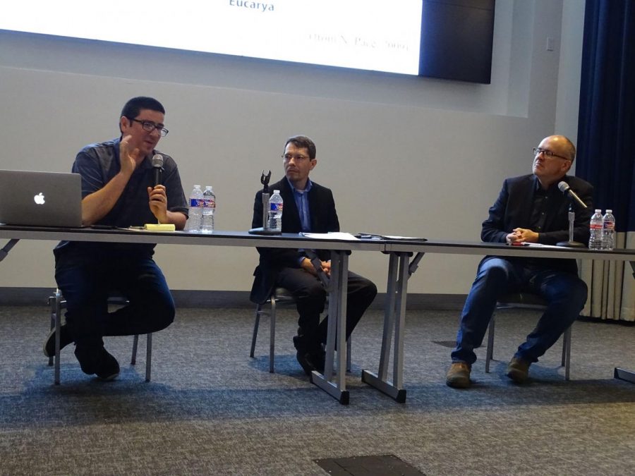 Joel Velasco, left, Stephen Dilley, center, and Paul Nelson, right, at a debate about Darwin's evolution theory Oct. 21.