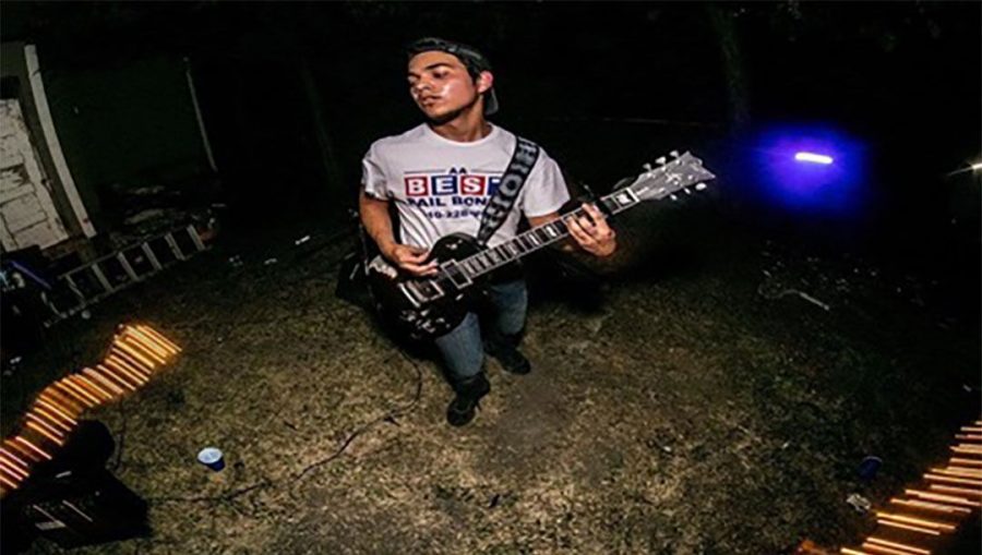 Freshman Matt San Martin plays the guitar at the 'Identity Crisis" EP release party Aug. 7, 2016.