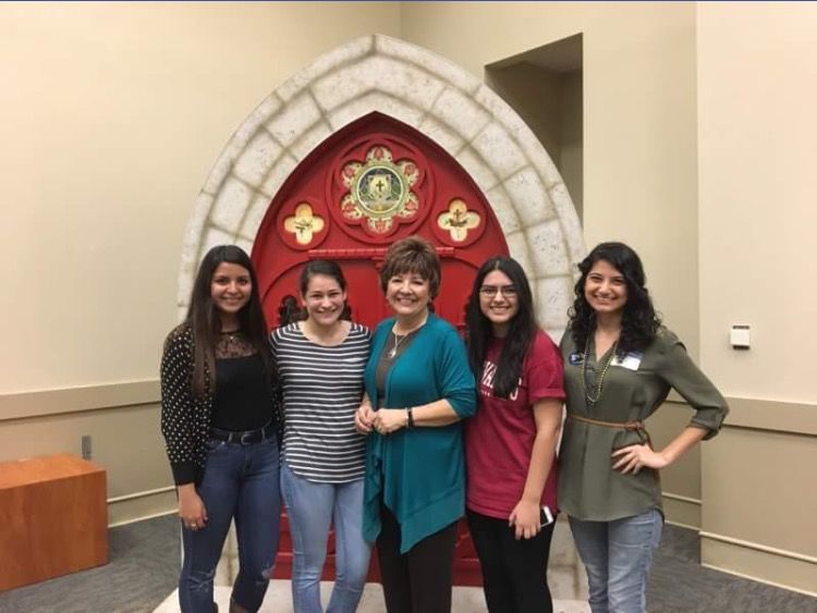 CAMP students pose in the Mabee Ballroom with program director Esther Yacono at anniversary celebration. 