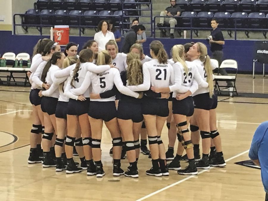 SEU volleyball huddles after winning their conference opener.