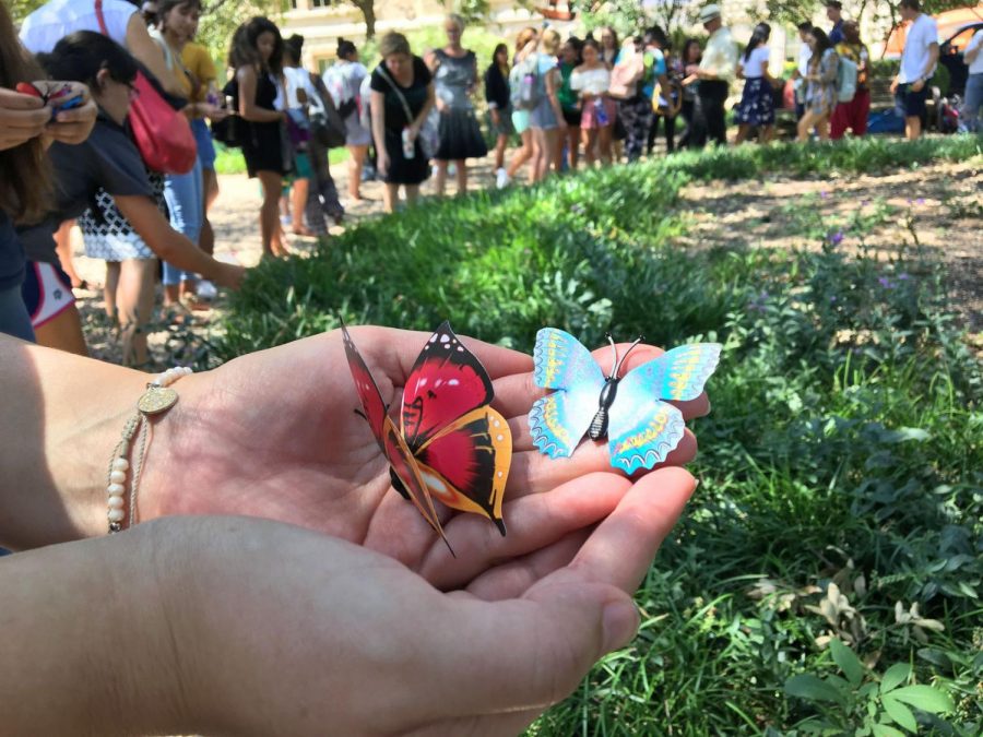 Attendees held monarch magnets symbolizing alliance.