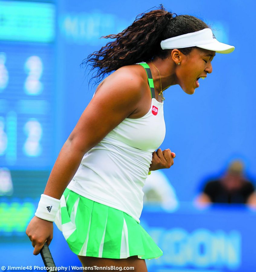 Naomi Osaka unleashes victory yell after a tennis match.