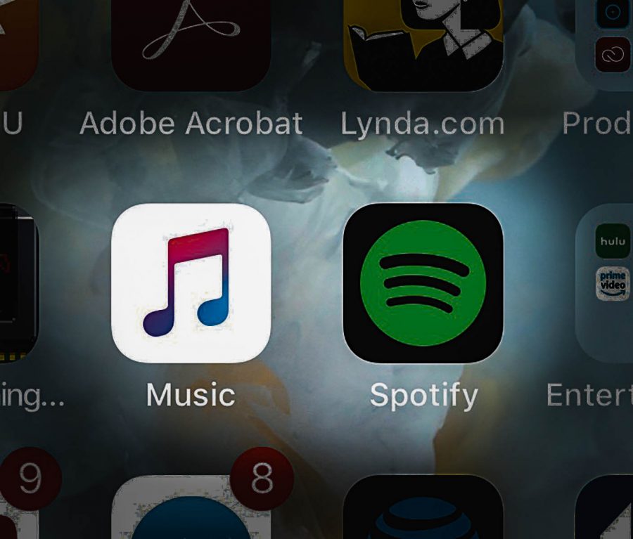 Spotify+and+Apple+Music+are+the+subjects+of+a+heated+music+streaming+debate.+