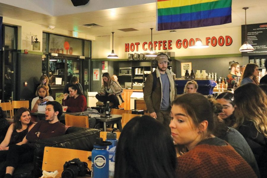 Community members gather at Jo's coffee shop to watch student performances. 