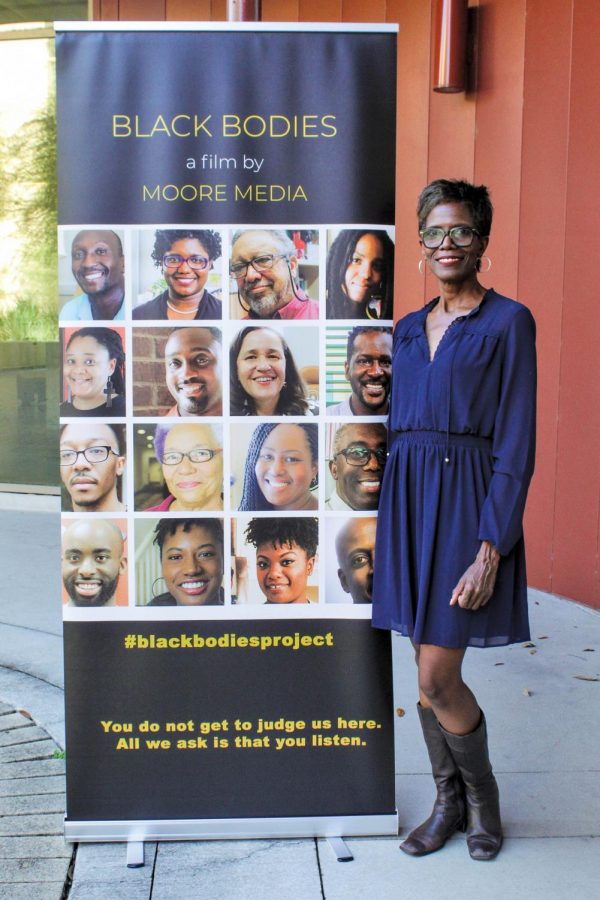 Charlotte Moore poses by the ‘Black Bodies Project’ poster. This is Moore’s first film.    