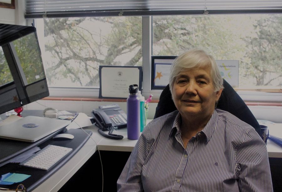 Professor Anna Escamilla sits in her office in Doyle Hall. She plans to retire at the end of the academic year.  