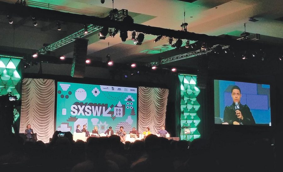 Trevor Noah speaks to a packed conference room. Noah’s contract as host of ‘The Daily Show’ extends until 2022. 