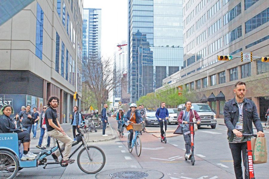 people ride the rentable scooters down 3rd street. The city has become overloaded with dockless mobility scooters, with almost 5,000 in the greater austin area alone