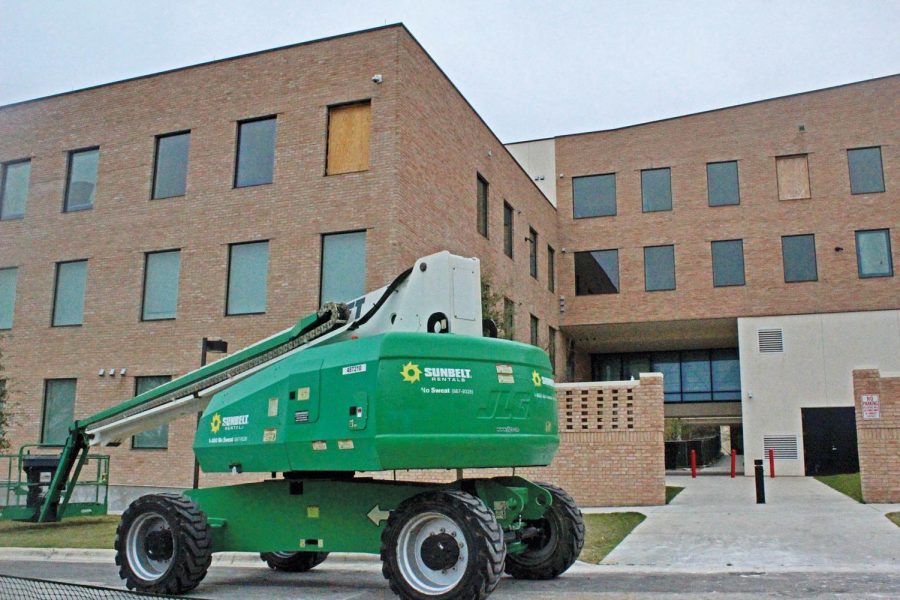 A construction vehicle sits parked next to the Pavilions residence hall. Administration claims it will be available for student living in time for the coming school year.