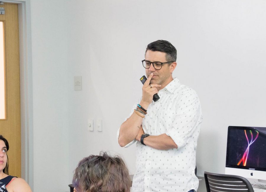 Professor Manuel Piña teaches a group of students. Piña believes sharing stories and elements from his personal life with students helps facilitate their education.