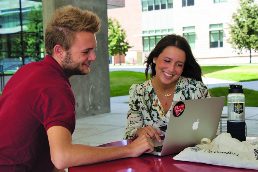 Titouan Grebot (left) and Alice Turelli, two foriegn exchage students from Europe, sit outside the village preparing for their first week of classes on the Hilltop.