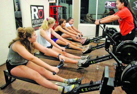 Rowing club president Jo Sanchez instructs fellow teammates on the proper rowing mechanics.