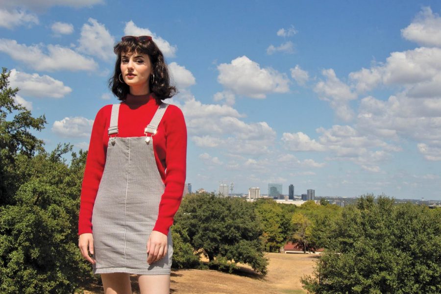 Allison Smith poses out by Main Building with the Austin skyline as her backdrop. Smith pulls style inspiration from famous rock stars and musicians. 