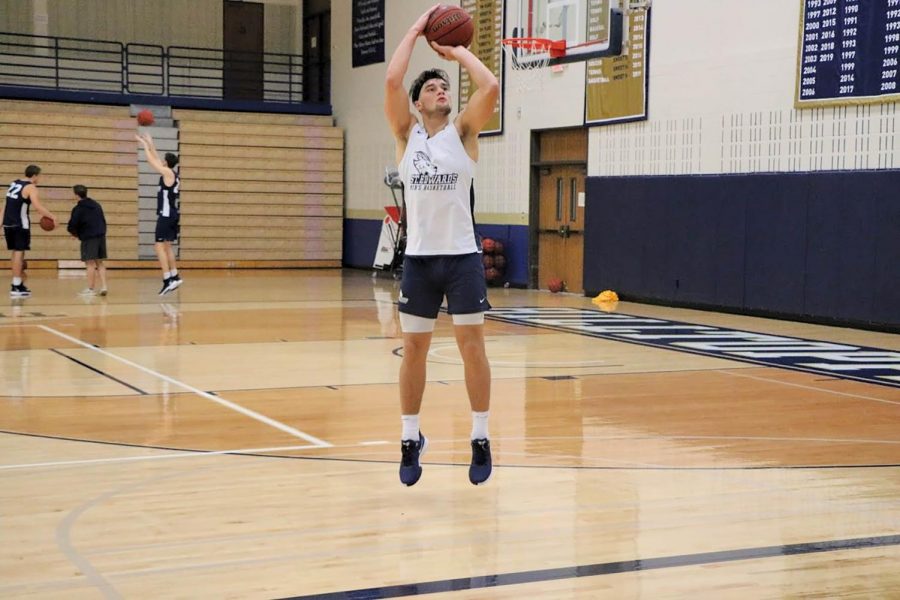 Senior guard August Haas gets shots up during practice. Last year, Haas averaged 10.3 points on 44% FG shooting.