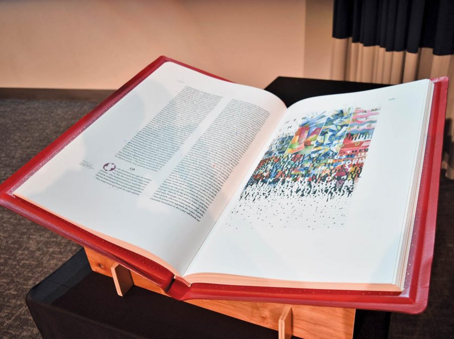 The+Saint+Johns+Bible+is+a+hand+illuminated+and+illustrated+text.+It+is+currently+on+display+in+the+Munday+Library.