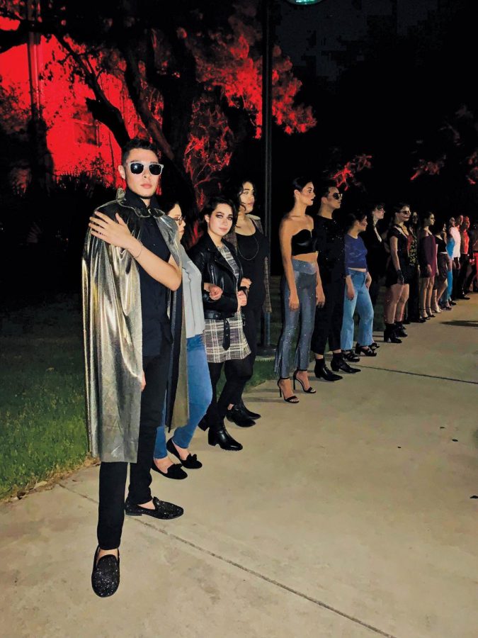 The team of designers and models, led by John Mascorro, pose following the show. Ana Jaime sports a black leather jacket. Jaime lead the makeup team, getting models ready in special-effects makeup.