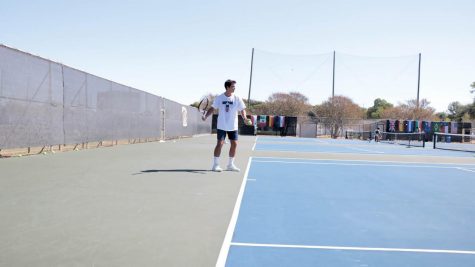 Junior tennis player Luis Diaz prepares to play a forehand during a team practice. Over his career on the hilltop, Diaz has accumulated a singles record of 29-13.