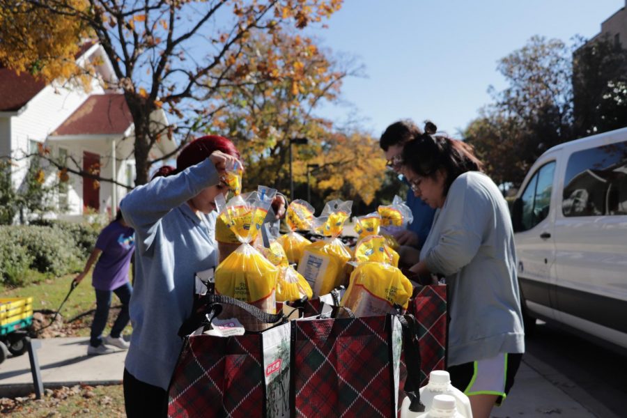 Volunteers fill donation bags with milk, bread, eggs and other perishables. The donations went to 50 Austin-area families.