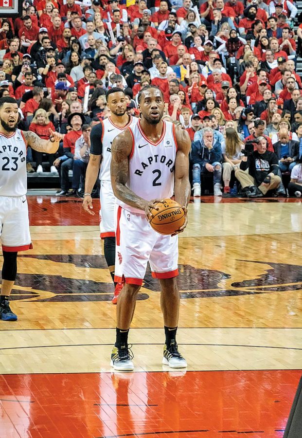 Kawhi Leonard prepares for a free throw during his lone season with the Toronto Raptors. Leonard believes that sitting out games played a factor in the team’s title run.