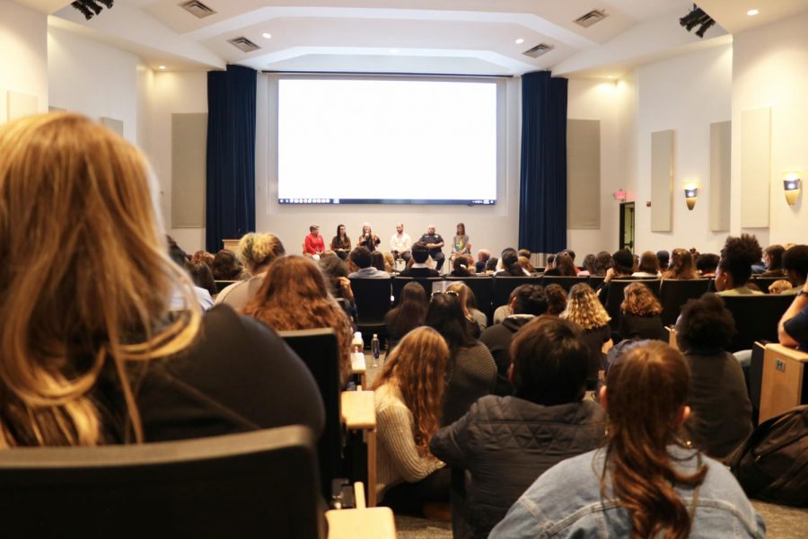 Jones+Auditorium+filled+to+capacity+following+an+announcement+SGA+and+IOU+made+Monday.+Attendees+sat+on+the+floor+and+stood+at+the+back+of+the+room+due+to+overflow.