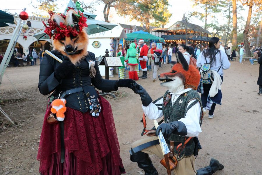 Costume-clad festival-goers stage an unconventional proposal for the camera. "I'll think about it," the female fox responded to the gesture. 