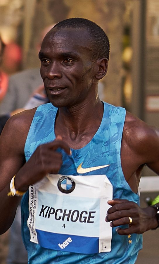 Recognized as the greatest marathon runner of the modern era, Eliud Kipchoge and other athletes have been criticized for setting records by “technology doping.” 