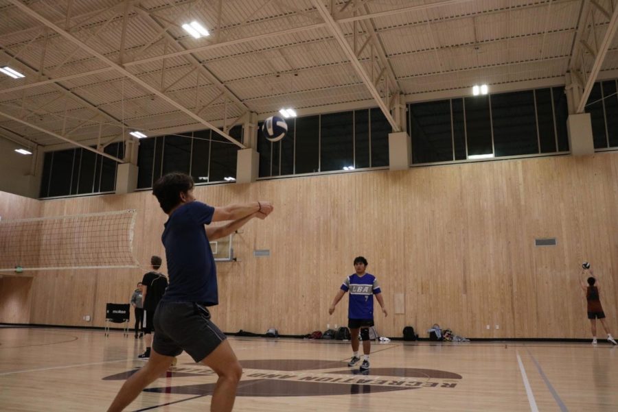 St. Edward’s student Rory O’Connor bumps volleyball to his warmup partner during a weekly practice. The club team practices Monday and Wednesday evenings. 