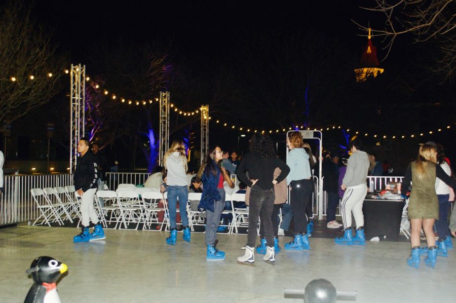 Students enjoy the ice-rink in blue skates with a view of the top of Main Building. Ice skating was free for all, and free donuts were provided as well. Students had a full weekend with the Homecoming Bash, the tailgate, a magician, hypnotist and ice skating. 