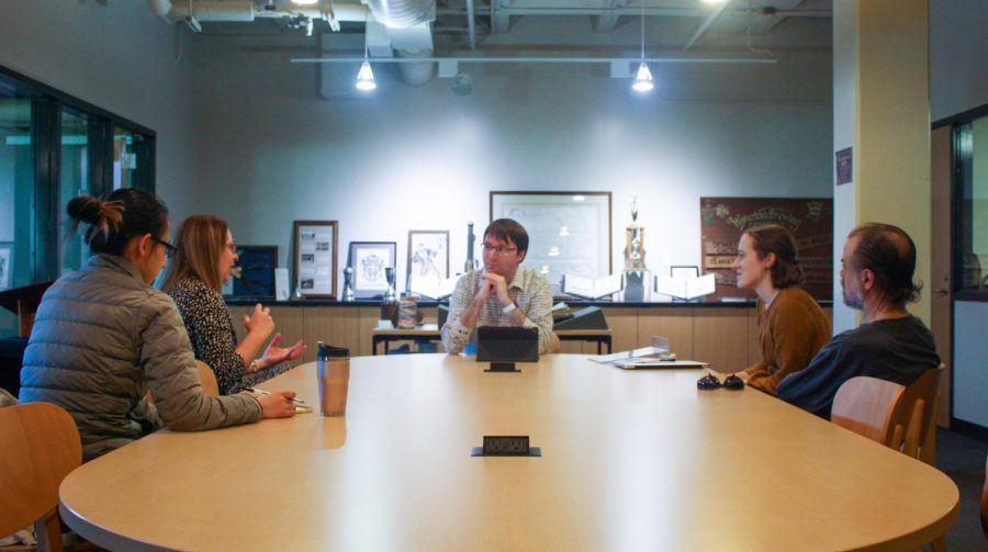 Travis Williams (center) is the only archivist for Munday Library. Williams oversees the Archives and Special Collections section of the library.